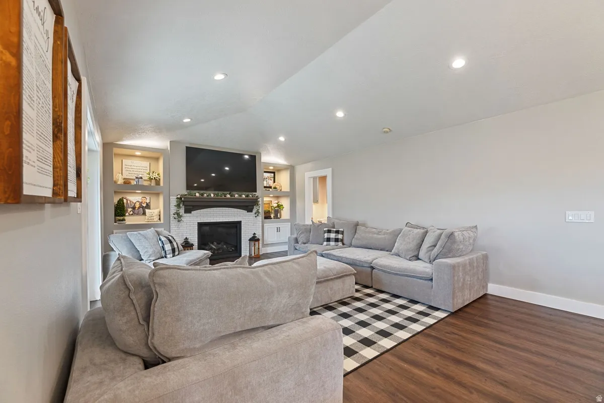 Living area featuring a fireplace with a tiled surround and dark wood mantel