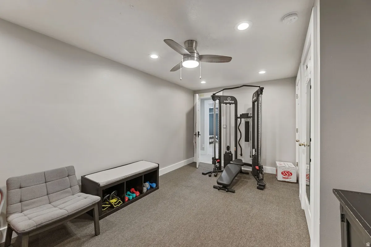Carpeted room with recessed lighting and a ceiling fan