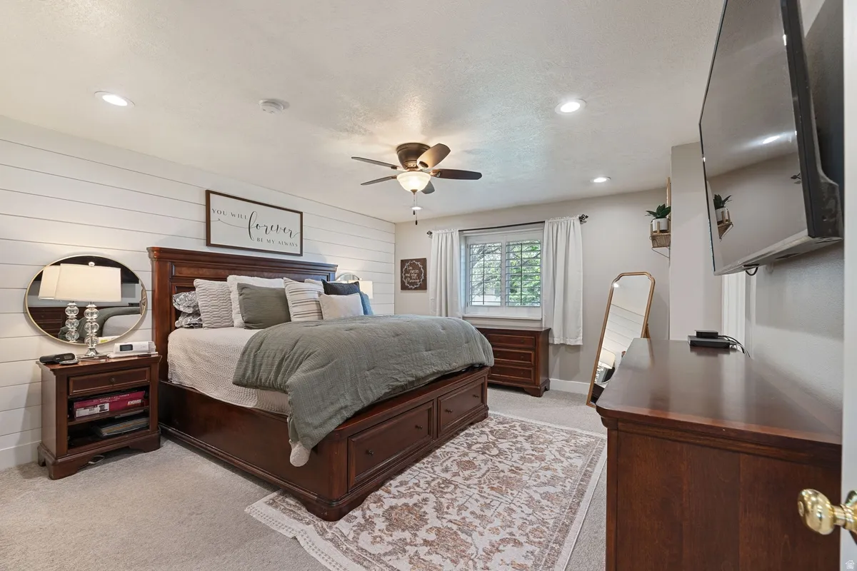 Spacious room featuring a shiplap accent wall, recessed lighting, and a ceiling fan