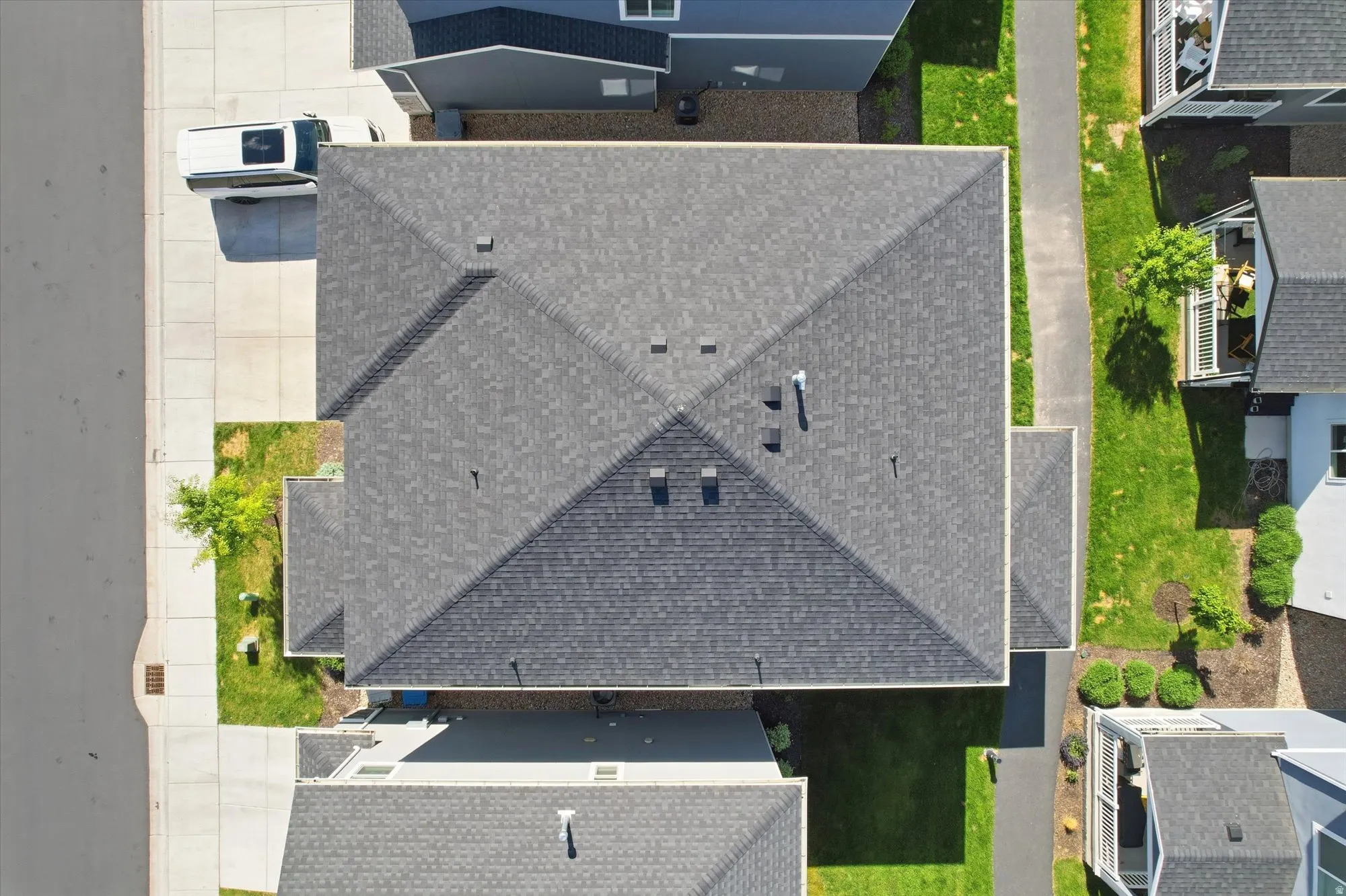 Gable and hip roof architecture with dark gray asphalt shingles