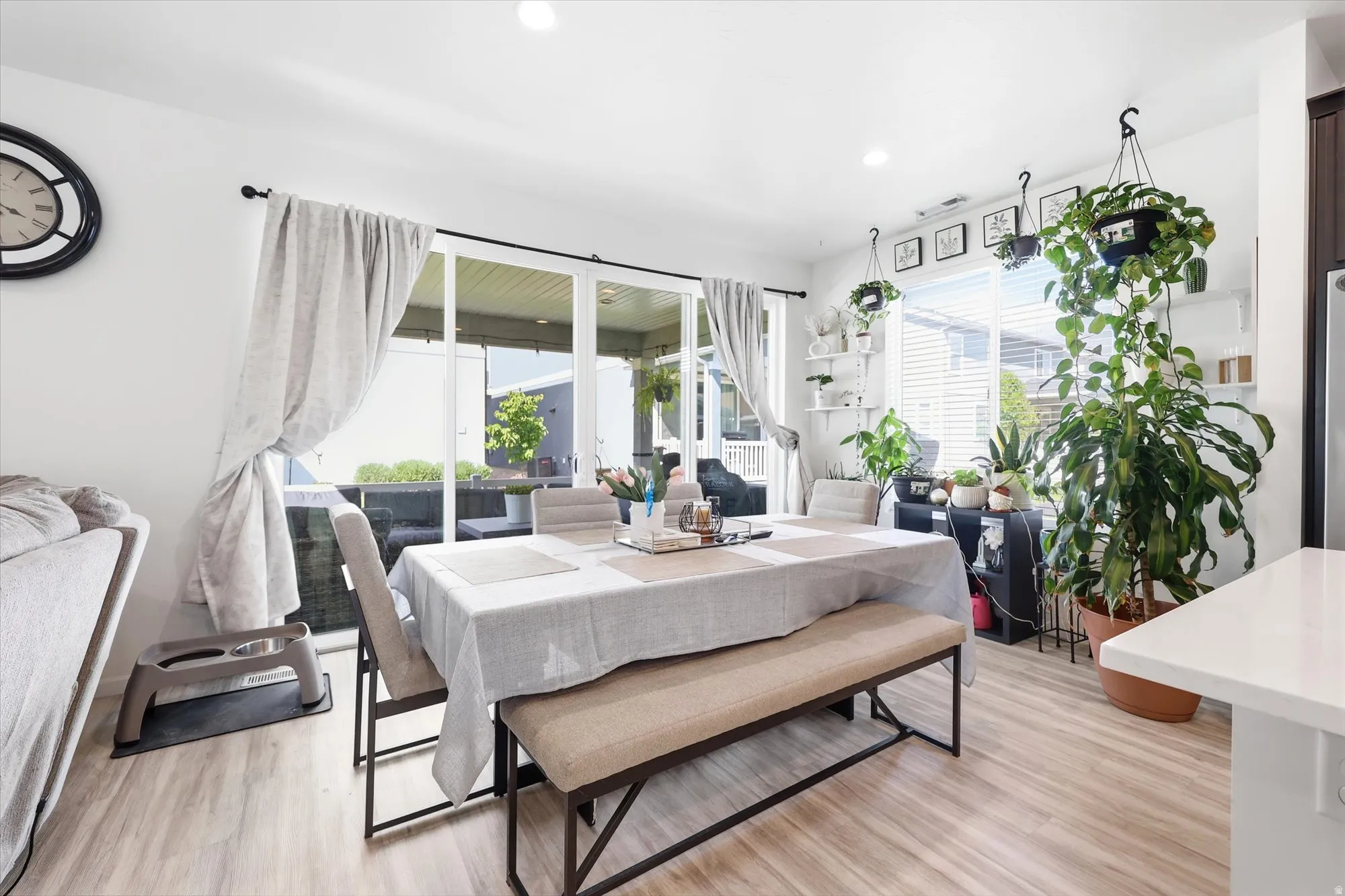 Dining area featuring wood-finish flooring, white walls, and recessed lighting