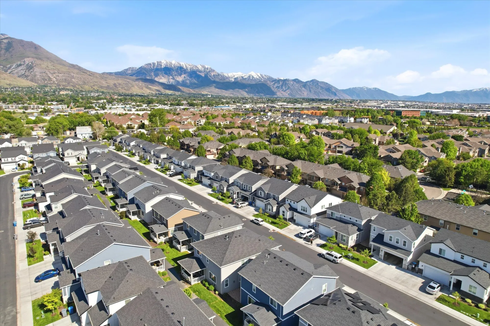 Aerial perspective of a developed residential neighborhood featuring a consistent architectural style with varying exterior colors