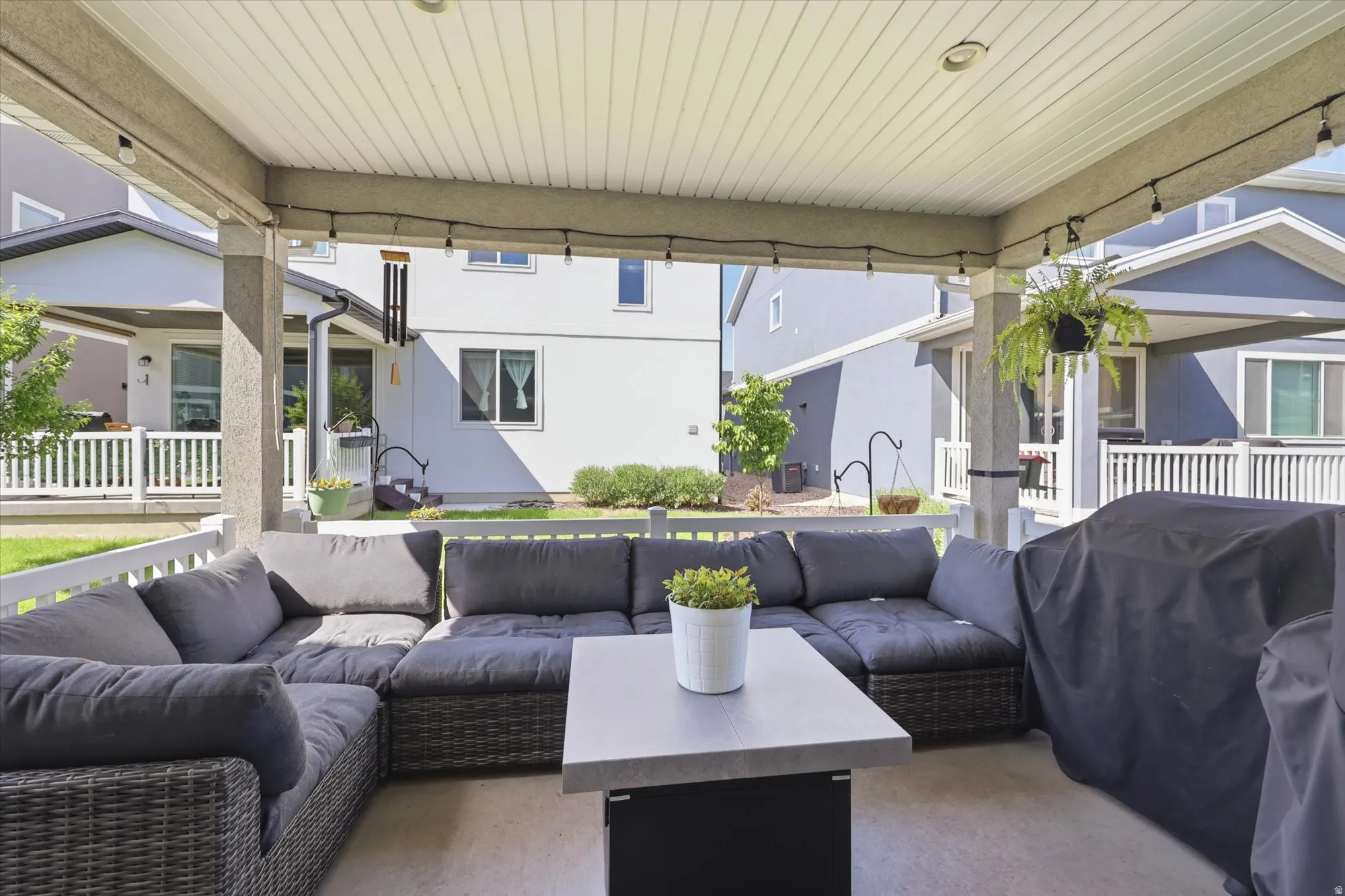 Covered patio featuring a concrete floor and a white paneled ceiling with recessed lighting