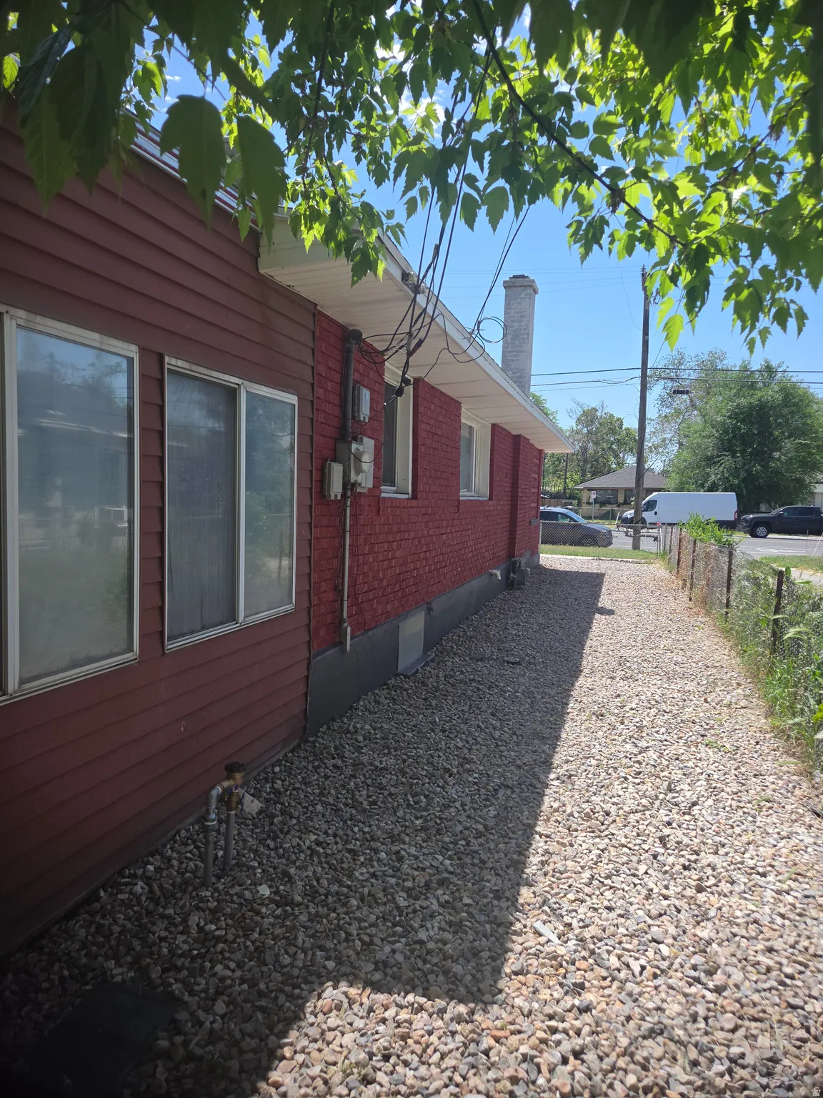 Exterior siding with red brick accents and white soffit