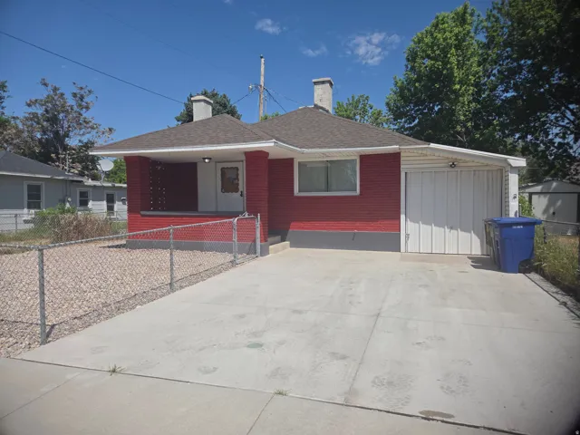 Red brick exterior with a covered front porch and concrete driveway