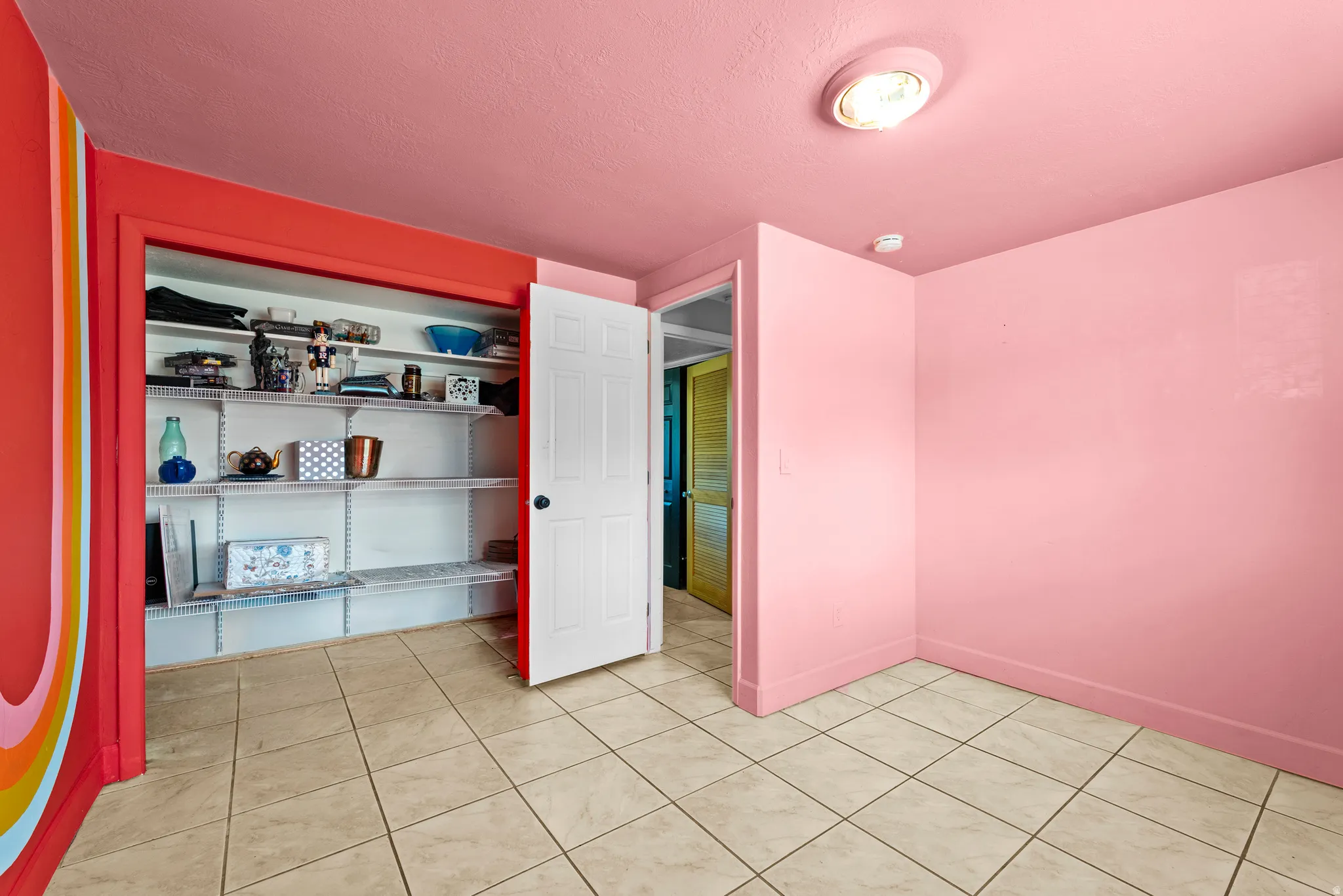 Bedroom featuring light-colored tile flooring, pink walls, and a recessed ceiling light fixture