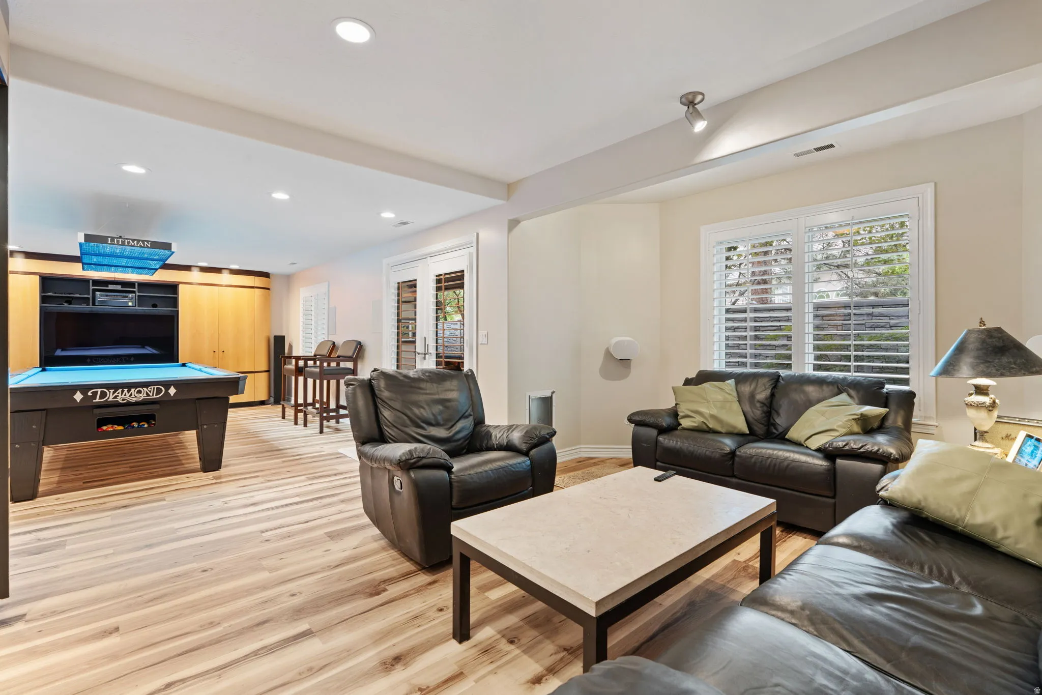 Spacious lounge area featuring wood-finish flooring with separate surround sound