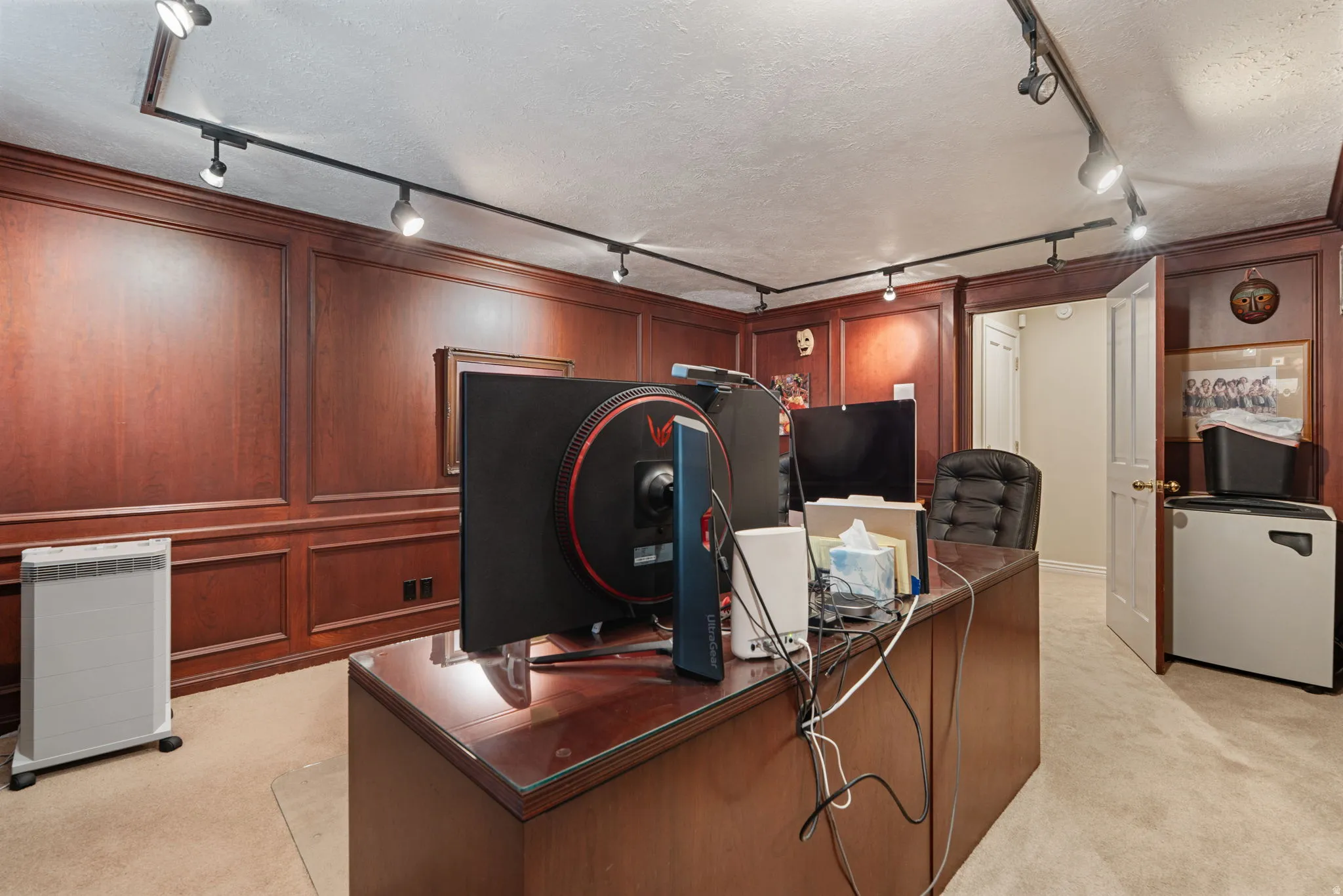 Library office room with cherry wood shelving and paneled walls