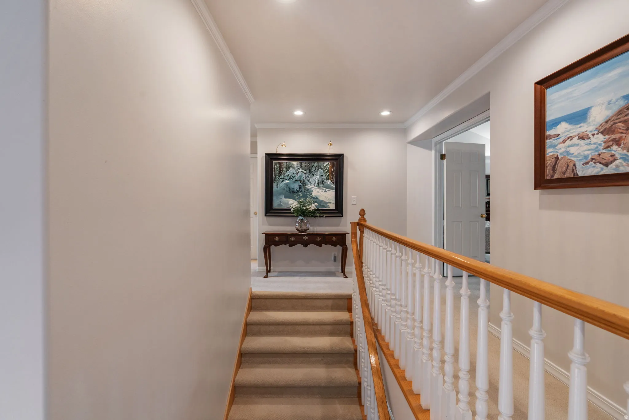 Staircase with wood handrail and white balusters