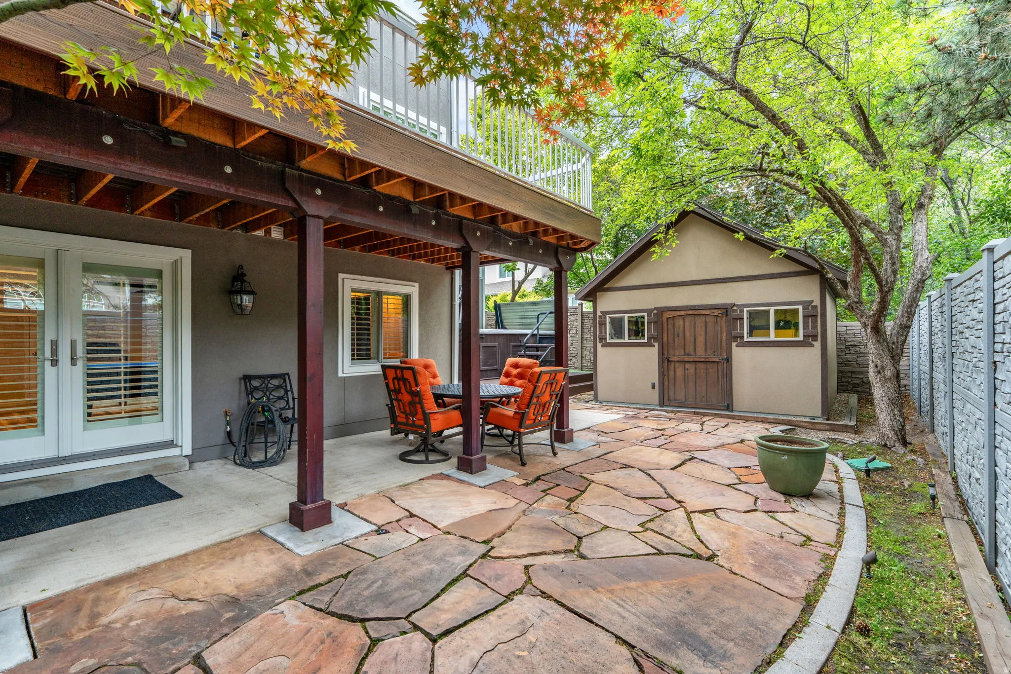 Covered outdoor area, custom cut stone walkway offering direct access via double French doors