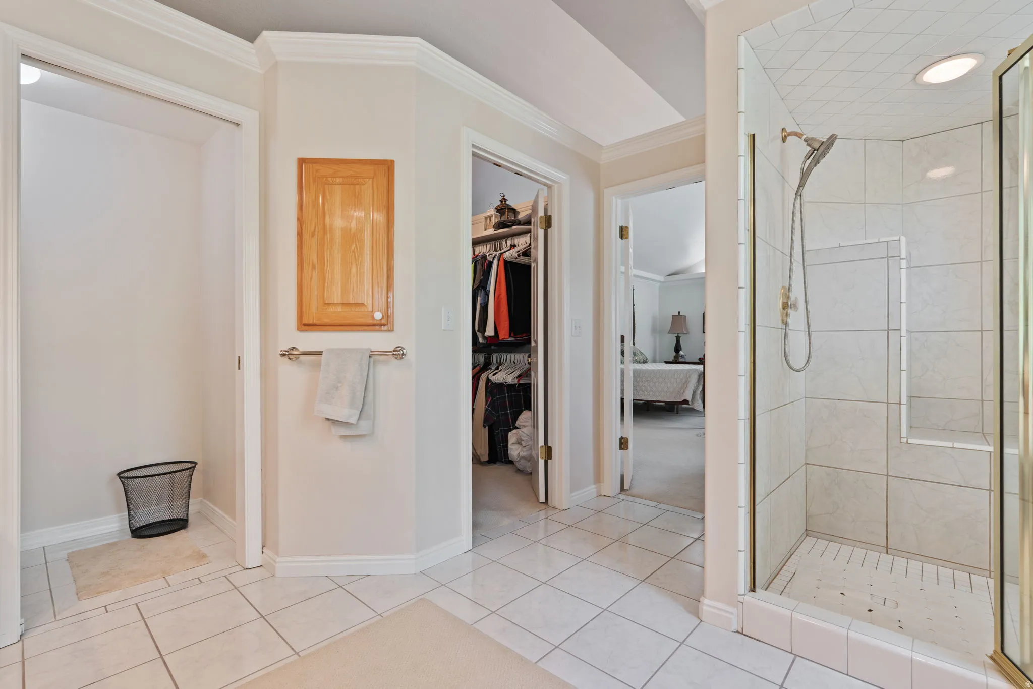 Tiled shower enclosure with glass surround and built-in bench, featuring a diamond-patterned tile ceiling