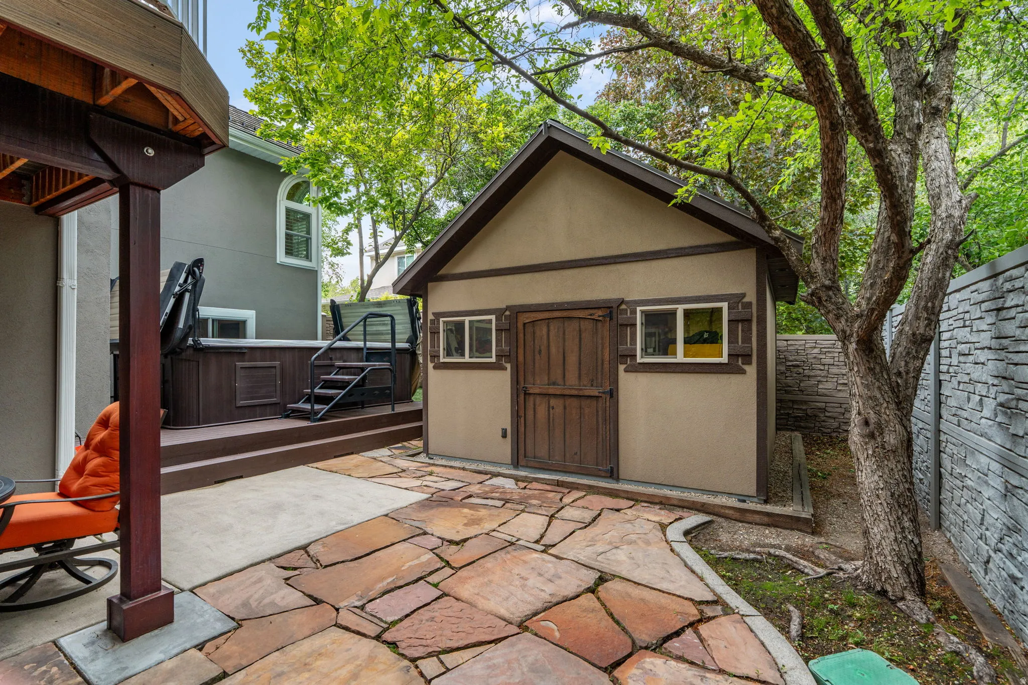 Custom cut stone patio with stucco sided storage shed