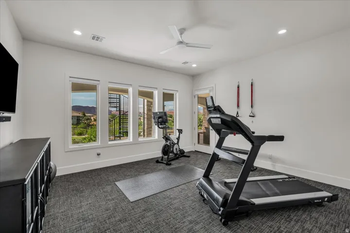 Bright interior space featuring recessed lighting, a ceiling fan, and carpeted flooring