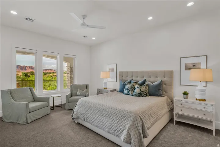 Spacious room featuring white walls and grey carpet flooring