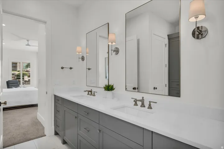 Double vanity featuring a light gray cabinet base and white countertops