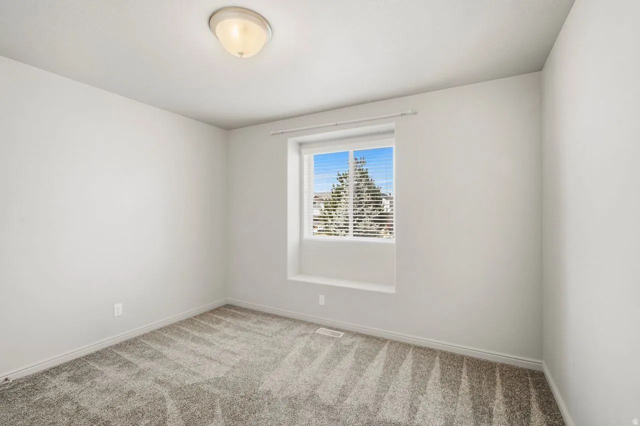 Neutral tone walls with a flush-mount ceiling light