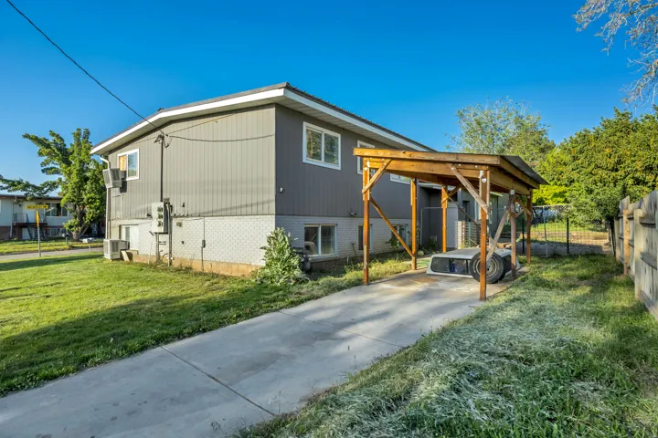 Exterior featuring gray horizontal siding and a white trim