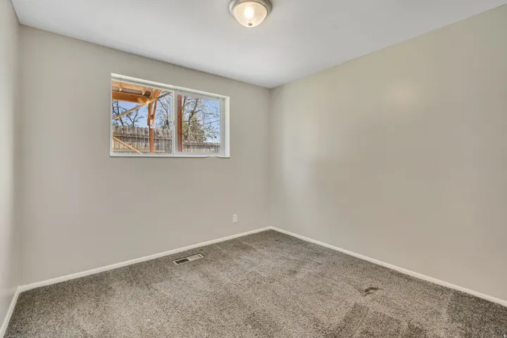 Neutral-toned walls complement the gray carpeting