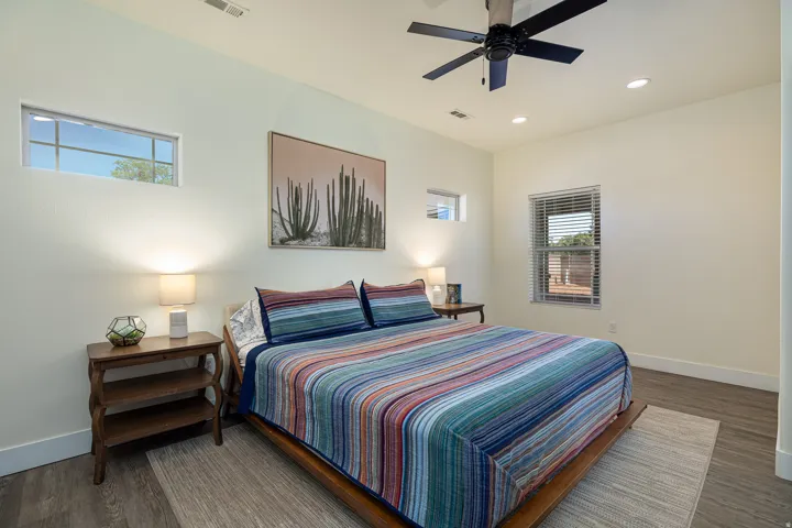 Primary Spacious bedroom featuring wood-finish flooring, recessed lighting, and a ceiling fan