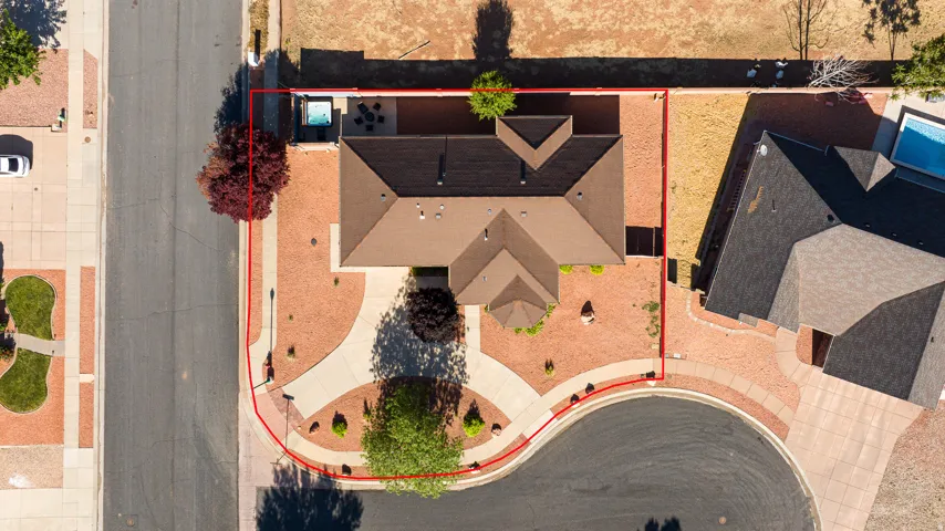 Aerial perspective showcasing a property with a distinct brown-shingled roof