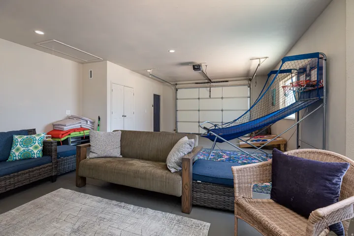 Versatile space with a panel garage door, recessed lighting, and a neutral color palette
