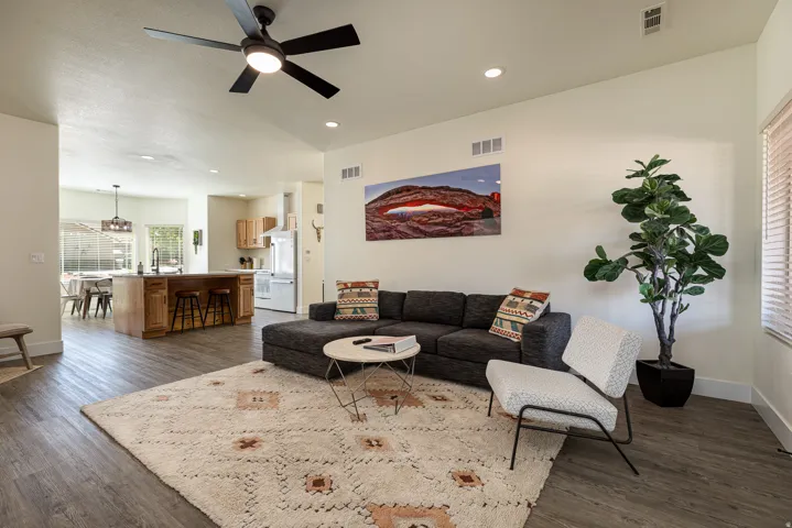 Open-concept living space featuring wood-finish flooring, recessed lighting, and a modern ceiling fan