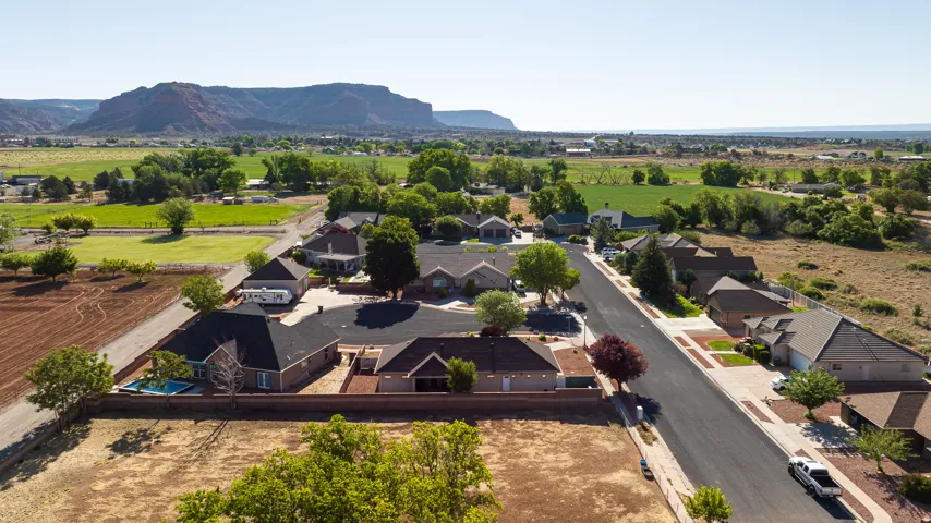 Residential community featuring single-story homes with dark asphalt shingle roofs and integrated garages