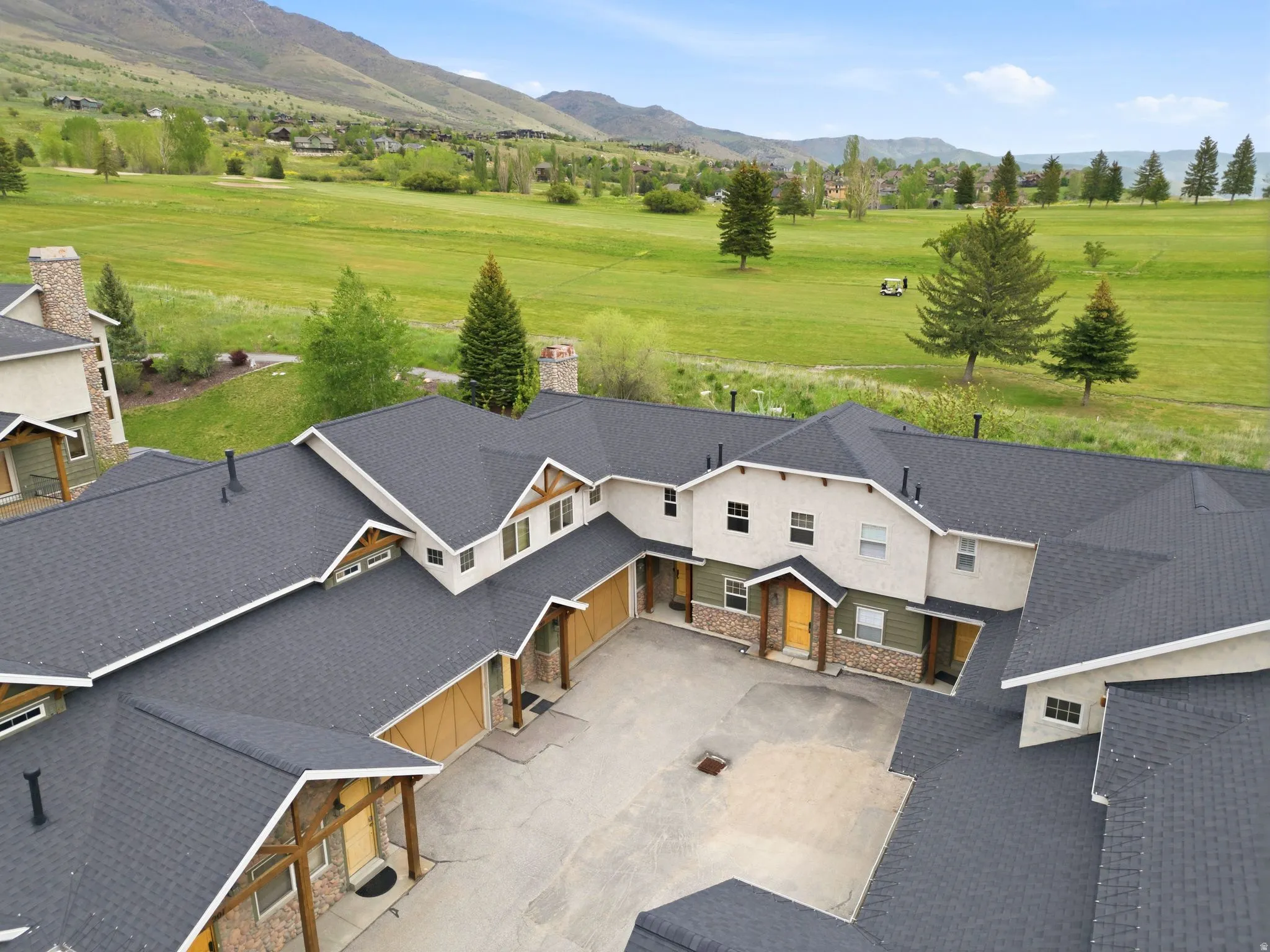 Multi-unit complex featuring an asphalt shingle roof