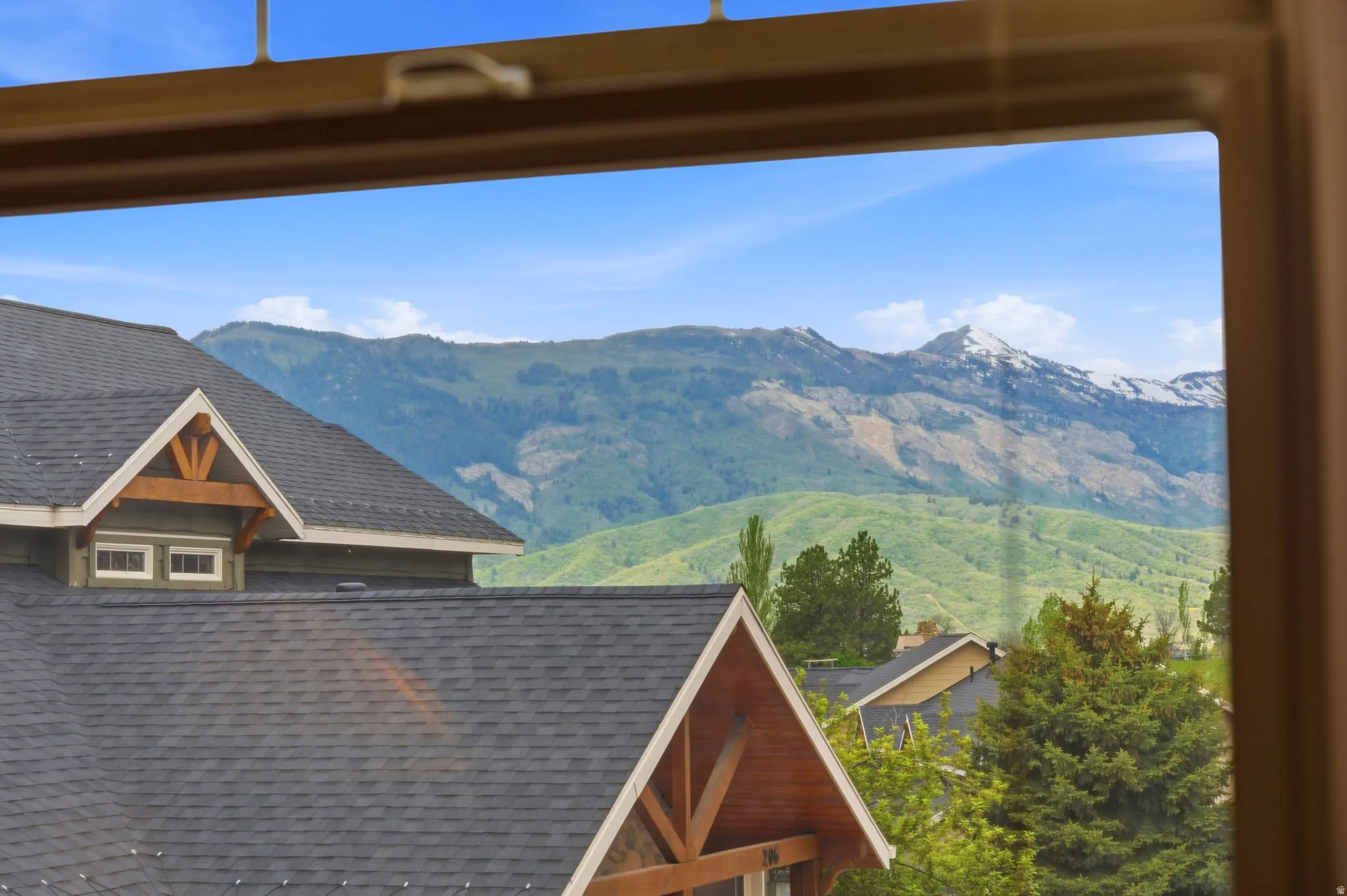 Mountain scenery featuring distant peaks and green hillsides