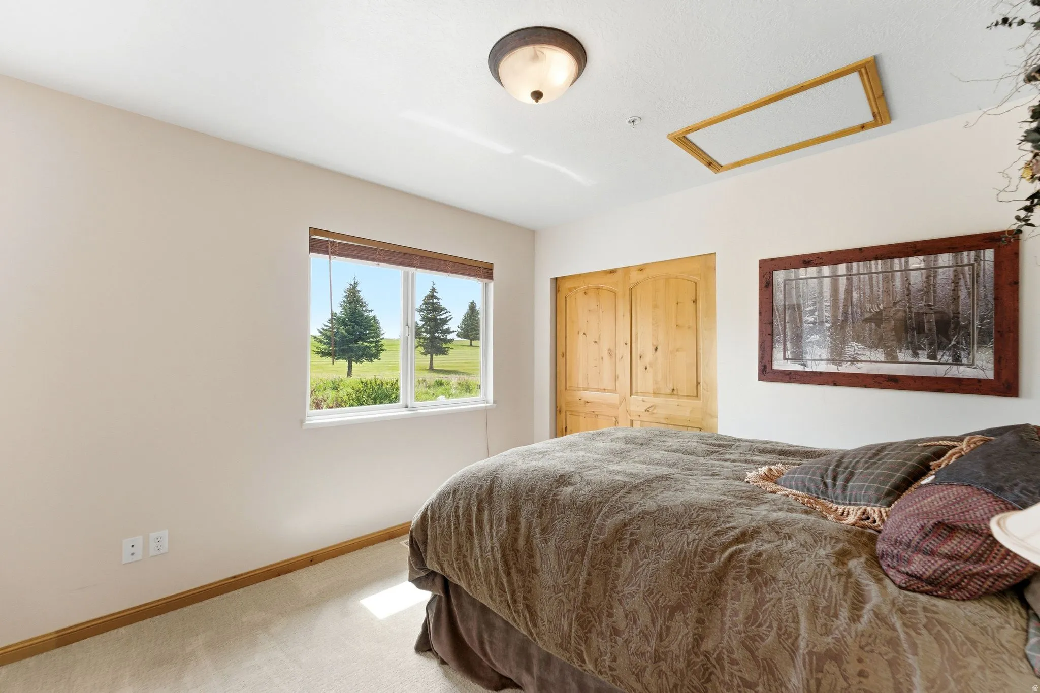 Double window framing a pastoral landscape