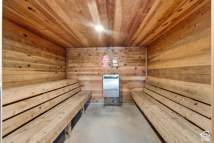 Interior sauna room featuring wood paneling on walls and ceiling