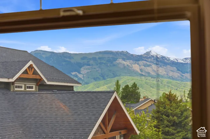 Mountain scenery featuring distant peaks and green hillsides