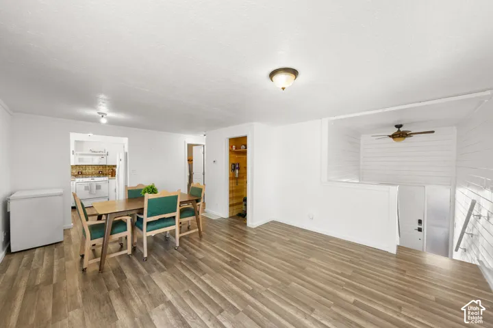 Wood-finish flooring throughout, with a dining area defined by a recessed ceiling light