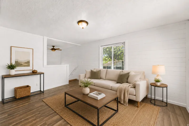 Wood-finish flooring throughout, white shiplap accent wall, white window blinds, and a flush mount ceiling light fixture