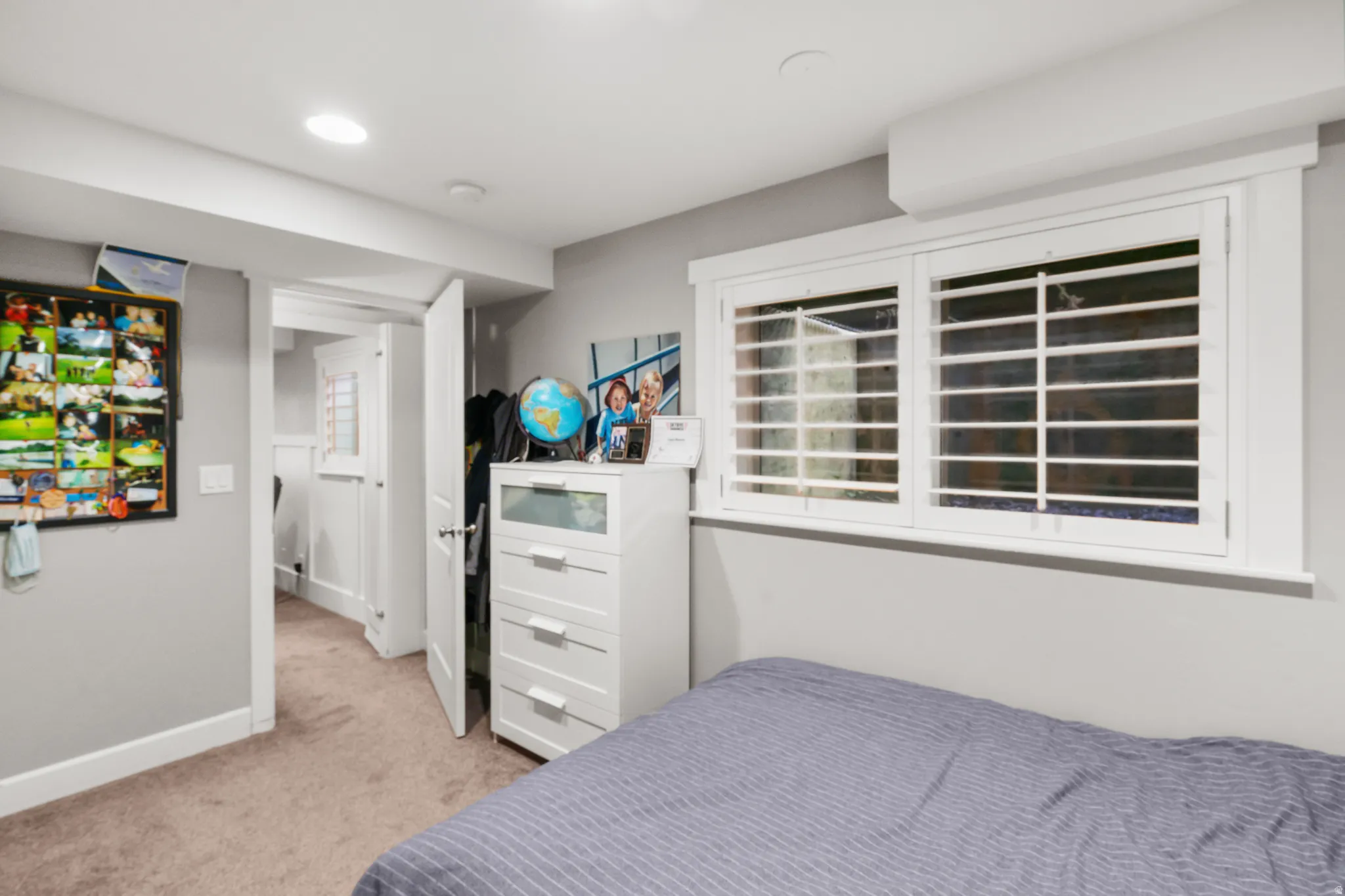 Window with white interior security bars, white trim, and a high sill