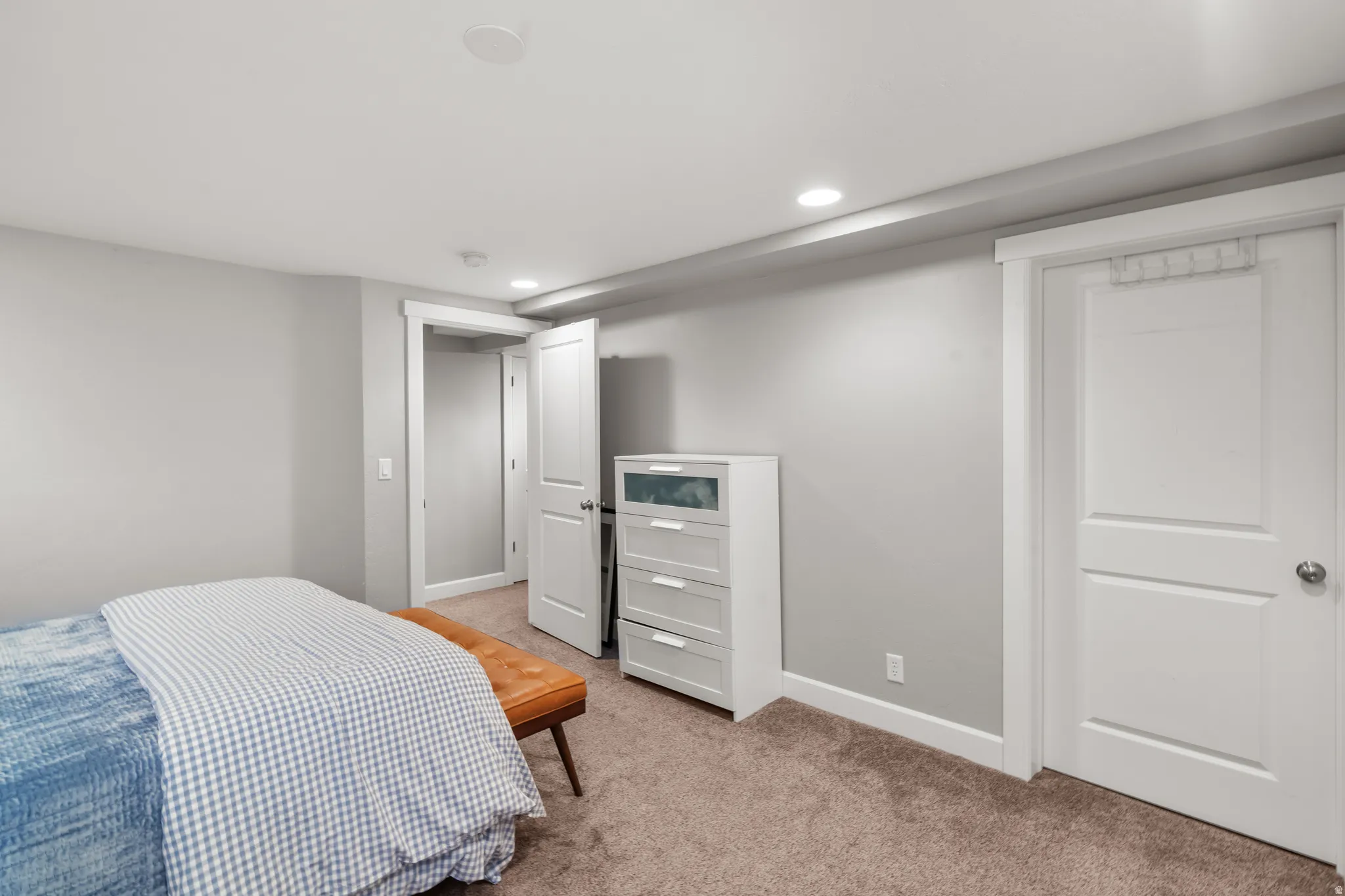 Carpeted room featuring recessed lighting, white baseboards, and white paneled doors