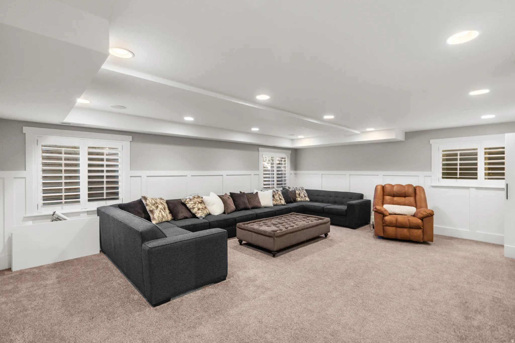 Spacious room featuring neutral carpet flooring, recessed lighting, and white plantation shutters