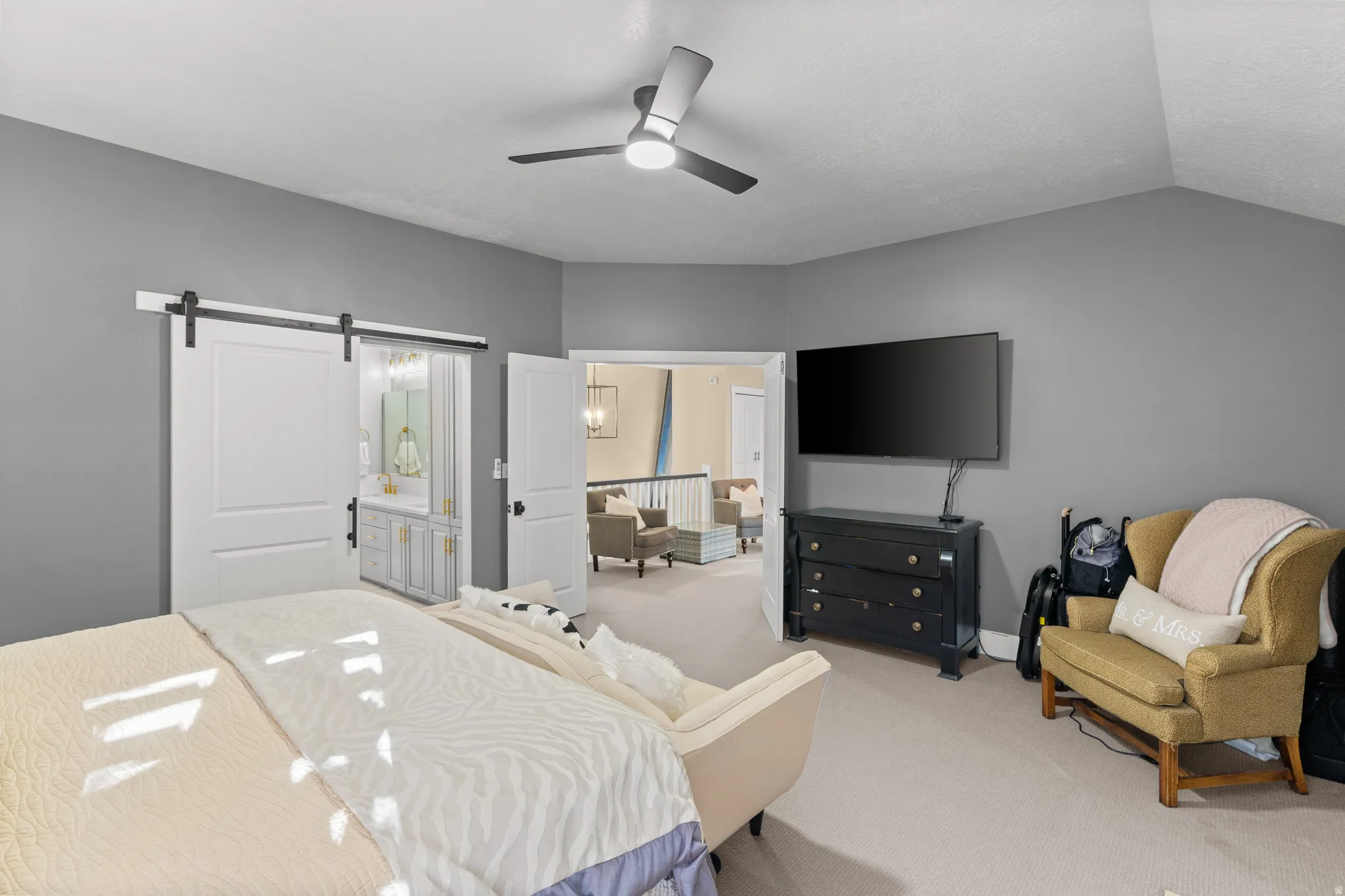 Spacious room with gray walls and light-colored carpeting