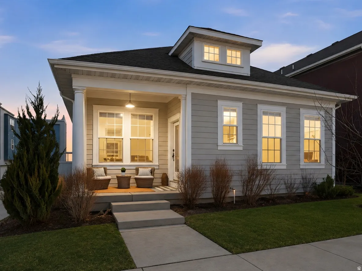 Single-story residence with a covered front porch and cream-colored siding exterior.