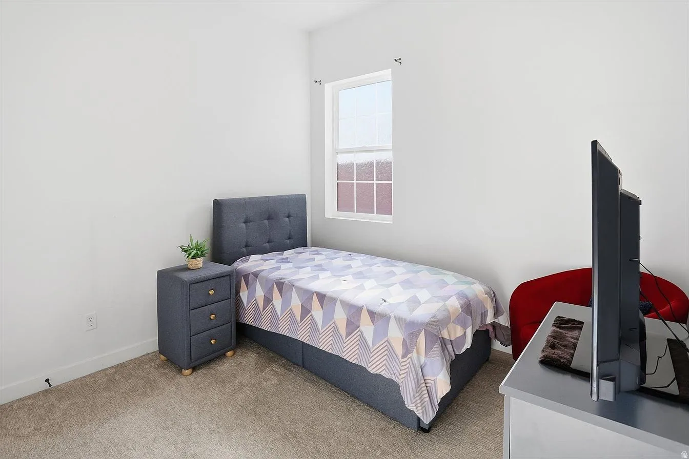 Room featuring neutral wall tones and carpeted flooring