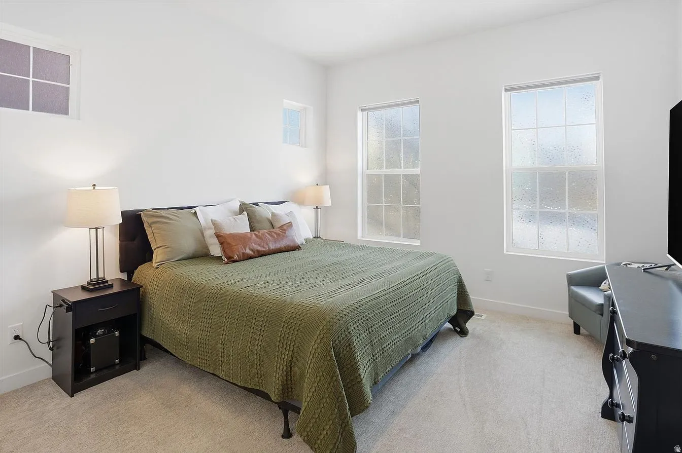 Spacious primary suite designed as a private retreat with room for a king-size bed and sitting area.