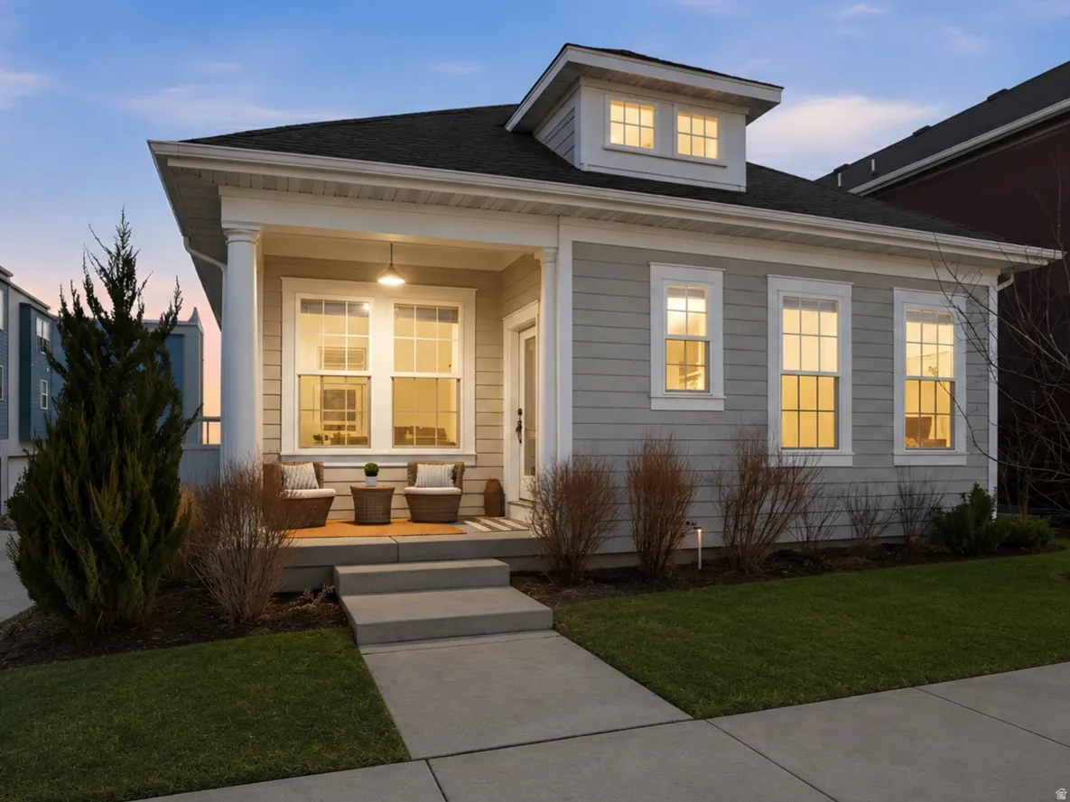 Cream-colored siding exterior with a welcoming covered porch.