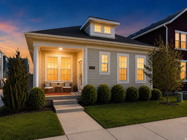 Single-story residence with a covered front porch and cream-colored siding exterior.