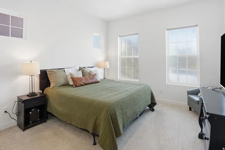 Spacious primary suite designed as a private retreat with room for a king-size bed and sitting area.