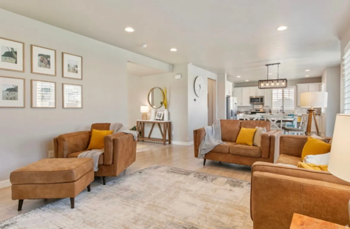 Open-concept living space featuring wood-finish flooring and recessed lighting