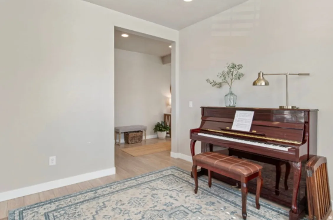 Well-lit interior space featuring neutral wall tones and light wood-finish flooring