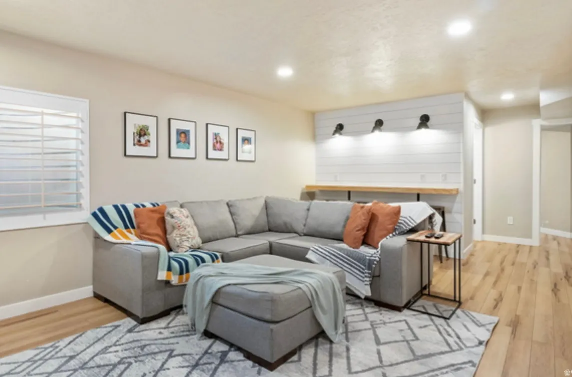 Living area featuring wood-finish flooring and recessed lighting