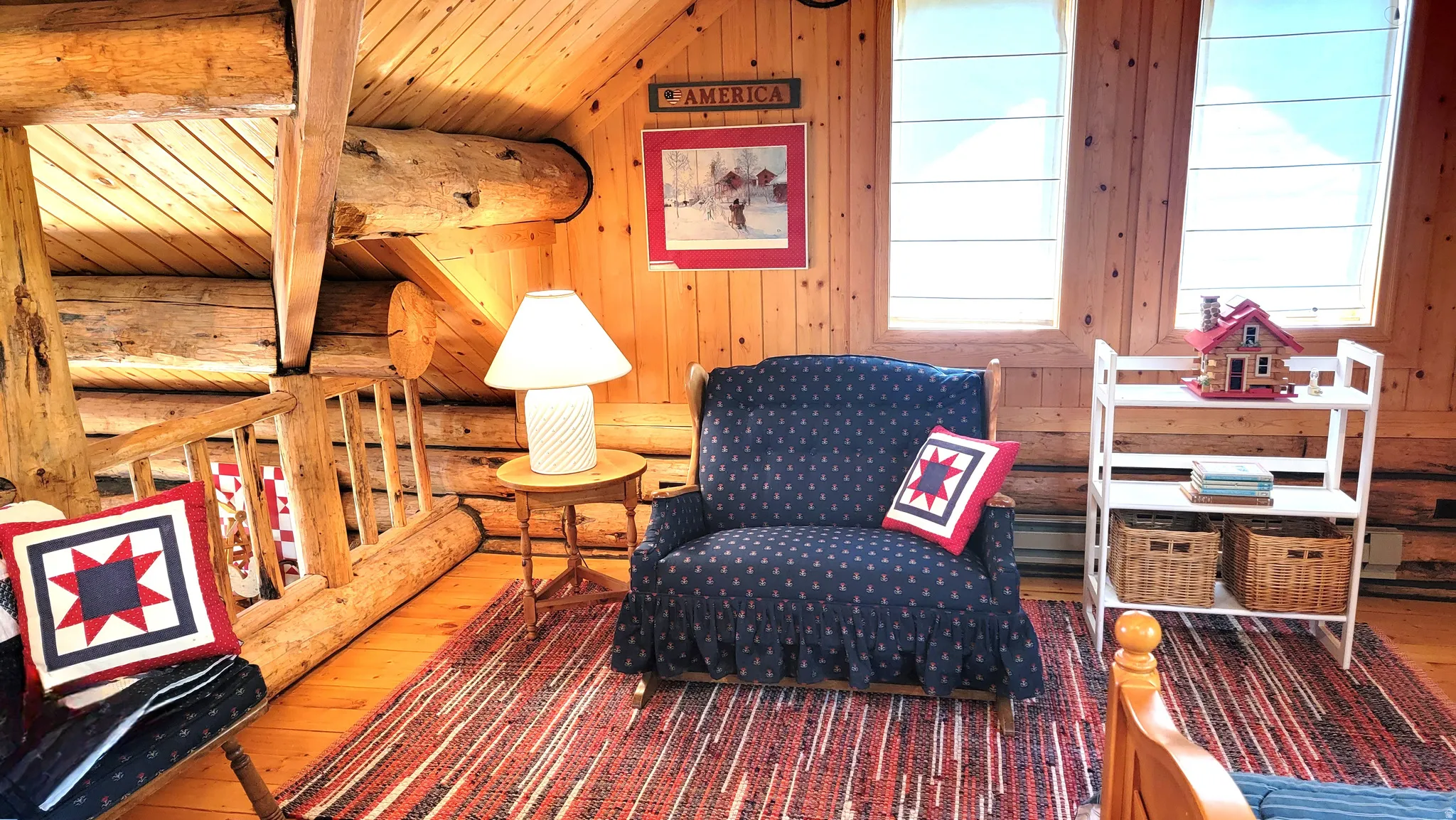 Sitting area of the loft with a rocking love seat. Perfect for bedtime stories and lullabies.