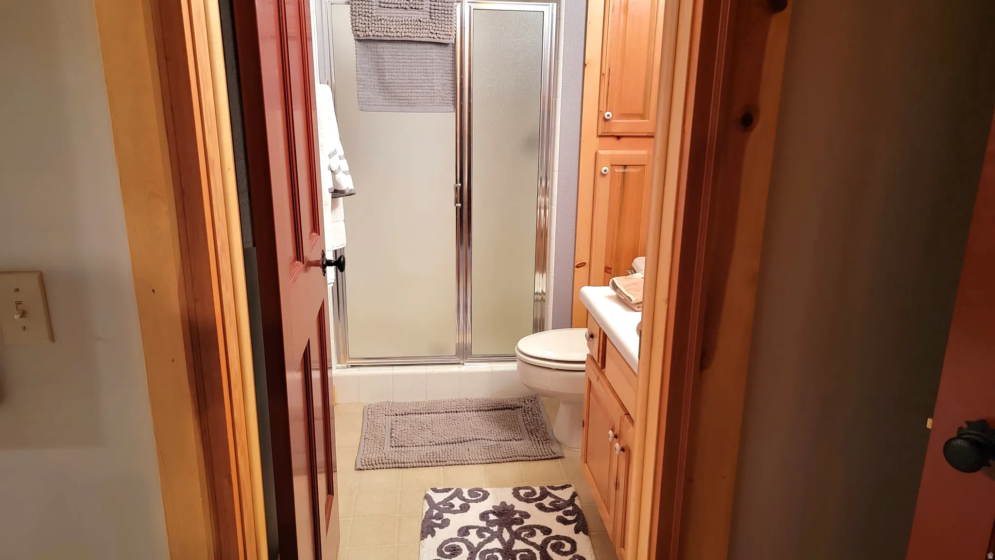 The bath has a large ceramic tile shower.