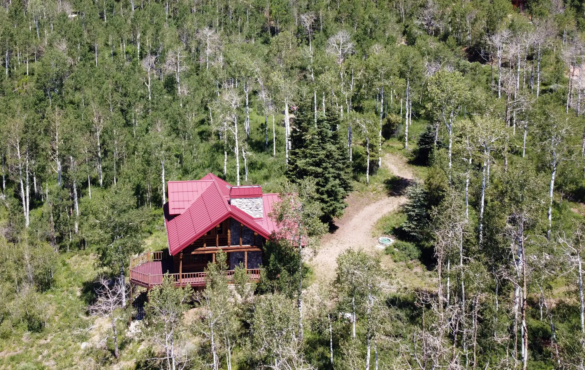 Aerial view south side of cabin with 2 story covered deck.